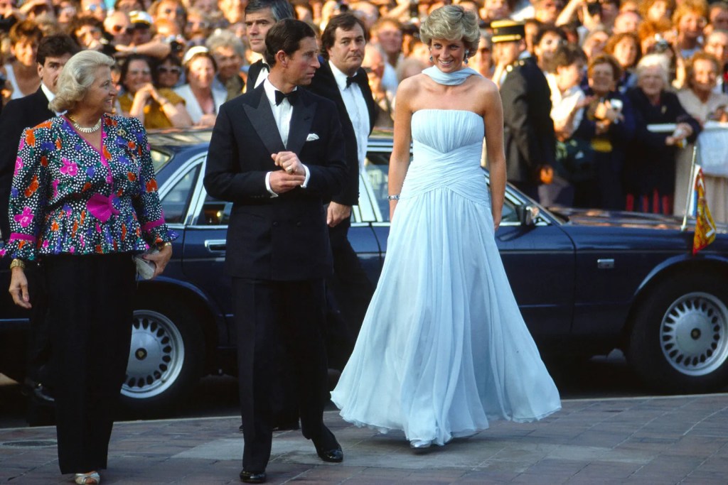 Princess Diana stepping out of a car at the Cannes film festival in 1987 in a blue dress with bridal scarf